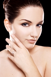 Beautiful woman showcasing diamond ring, highlighting elegance and confidence.