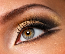 Golden-brown eye makeup highlighting lashes, enhancing beauty for Latisse promotion.