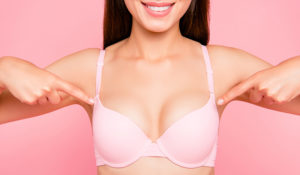 Natural breast augmentation results with a confident, smiling patient.