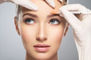 woman getting cosmetic injection in forehead