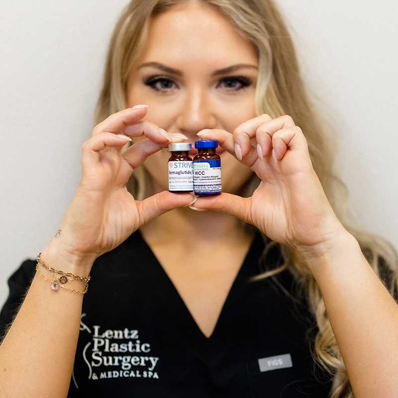 Aesthetic specialist at Lentz Plastic Surgery & Medical Spa holding vials of Semaglutide and MICC medication.